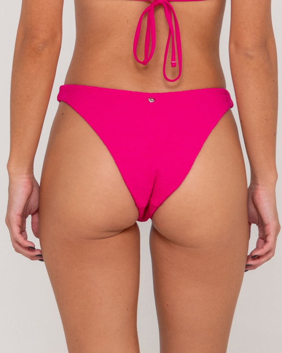 woman-wearing-sandalwood-midi-bikini-bottom-in-fuchsia