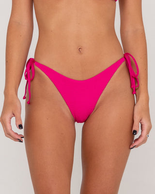 Woman wearing Sandalwood Midi Side Ties Bikini Bottom in Fuchsia