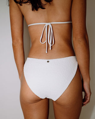 Woman wearing Sandalwood Classic Bikini Bottom in Bright White