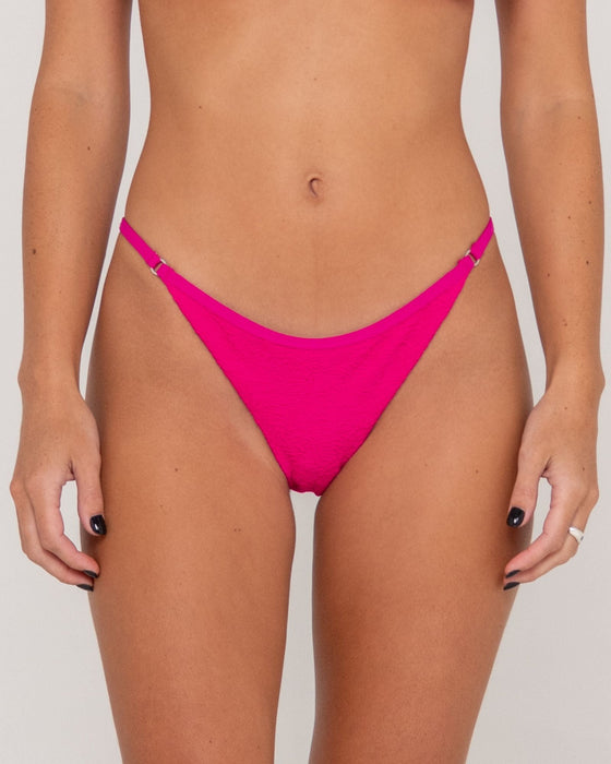 woman-wearing-sandalwood-ring-cheeky-bikini-bottom-in-fuchsia