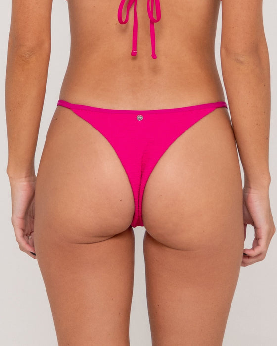 woman-wearing-sandalwood-ring-cheeky-bikini-bottom-in-fuchsia