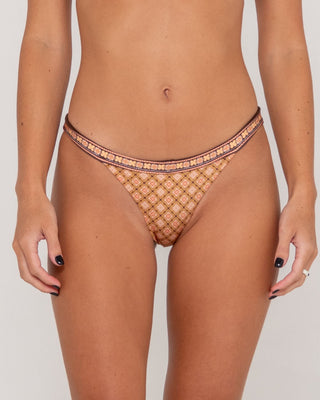 Woman wearing Georgie Geo Midi Bikini Bottom in Sunset Orange