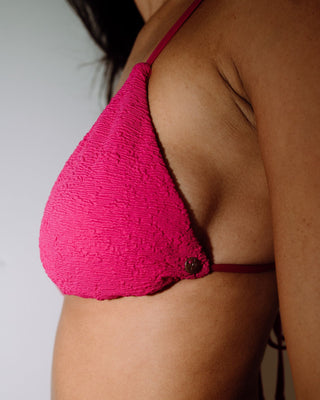 Woman wearing Sandalwood Ring Bikini Top in Fuchsia