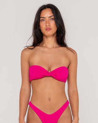 Woman wearing Sandalwood Bandeau Twist Bikini Top in Fuchsia