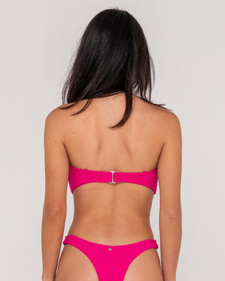 Woman wearing Sandalwood Bandeau Twist Bikini Top in Fuchsia