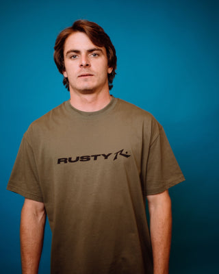 Man wearing Vital Rusty Short Sleeve Tee in Savanna