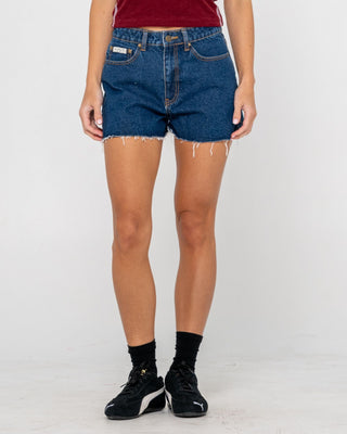 Woman wearing Penny Kick Flare Denim Short in Deep Sea Blue