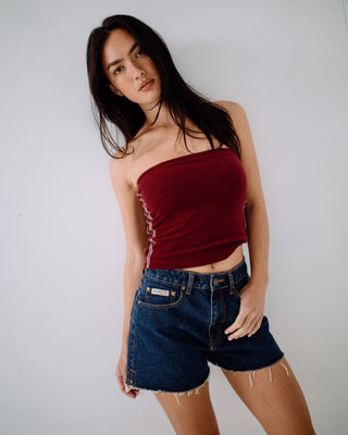 Woman wearing Penny Kick Flare Denim Short in Deep Sea Blue