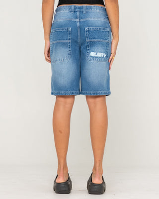 Woman wearing Flip Mommy Low Rise Wide Leg Denim Jort in Blasted Middy Blue / Blue