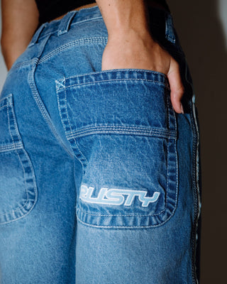 Woman wearing Flip Mommy Low Rise Wide Leg Denim Jort in Blasted Middy Blue / Blue