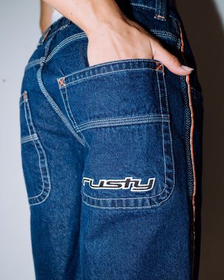 Woman wearing Flip Mommy Low Rise Wide Leg Denim Jort in Deep Sea Blue / Orange