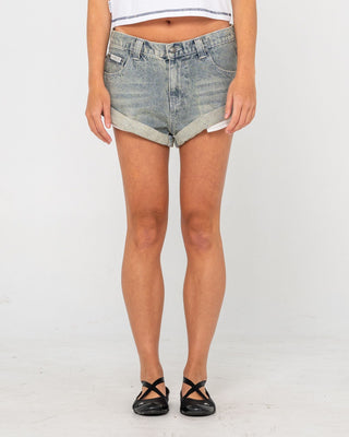 Woman wearing Pheonix Low Rise Denim Mini Short in Dirty Dawg
