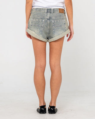 Woman wearing Pheonix Low Rise Denim Mini Short in Dirty Dawg