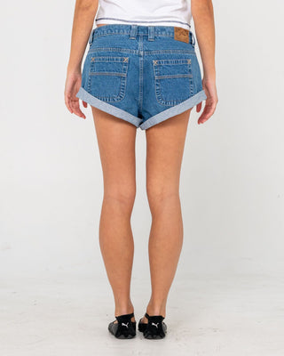 Woman wearing Pheonix Low Rise Denim Mini Short in Middy Blue
