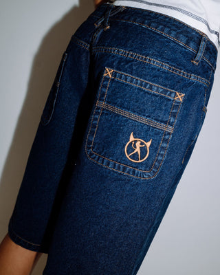 Woman wearing Bethany Baggy Low Rise Denim Jort in Deep Sea Blue