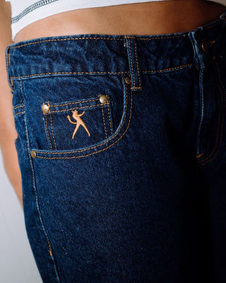 Woman wearing Bethany Baggy Low Rise Denim Jort in Deep Sea Blue