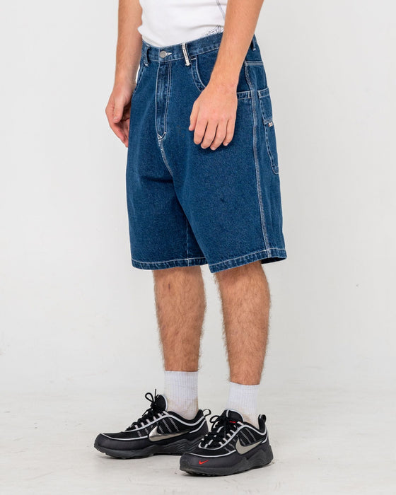 man-wearing-flip-daddy-tapeless-jort-deep-sea-blue-in-deep-sea-blue