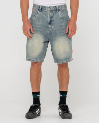 Man wearing Flip Daddy 2.0 Jort - Dirty Dawg in Dirty Dawg / Orange