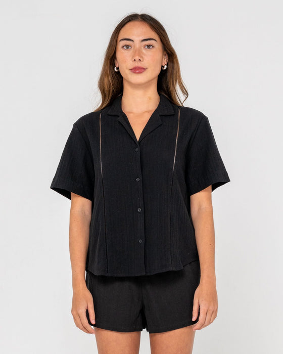 woman-wearing-rummer-has-it-short-sleeved-shirt-in-black