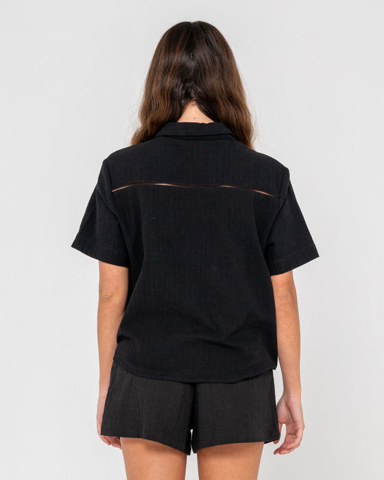 woman-wearing-rummer-has-it-short-sleeved-shirt-in-black