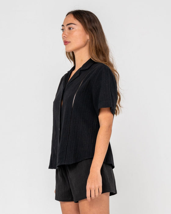 woman-wearing-rummer-has-it-short-sleeved-shirt-in-black