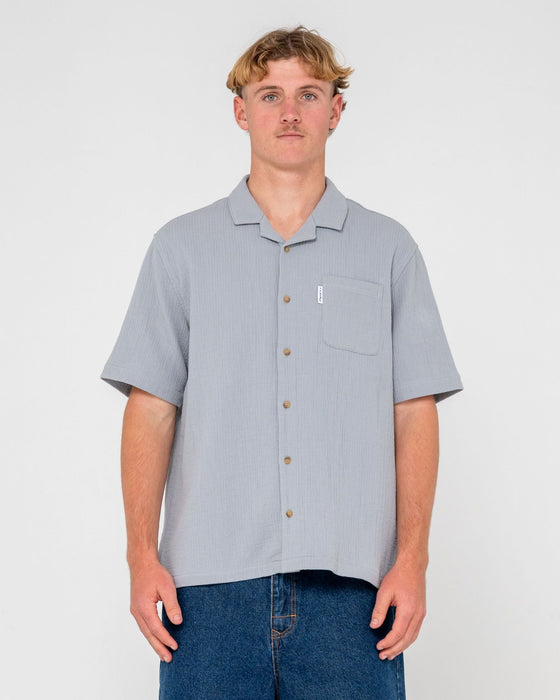 man-wearing-canseco-vacation-short-sleeve-shirt-in-ultimate-grey