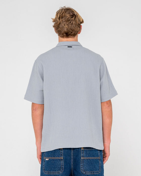 man-wearing-canseco-vacation-short-sleeve-shirt-in-ultimate-grey