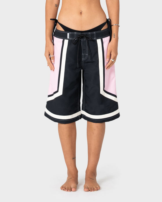 woman-wearing-farrah-long-boardshorts-in-black-pink