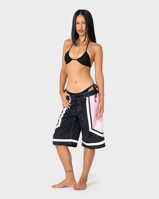 Woman wearing Farrah Long Boardshorts in Black / Pink