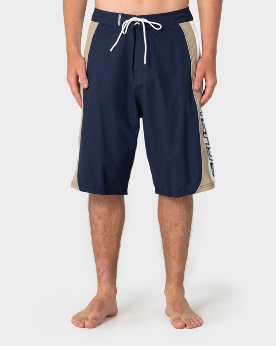 man-wearing-power-wing-fixed-waist-boardshort-in-navy-blue