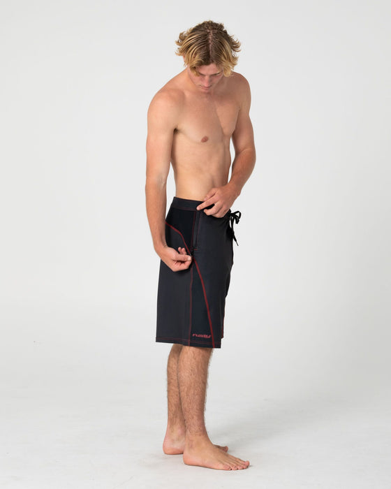 man-wearing-hydro-surge-fixed-waist-boardshort-in-black-1