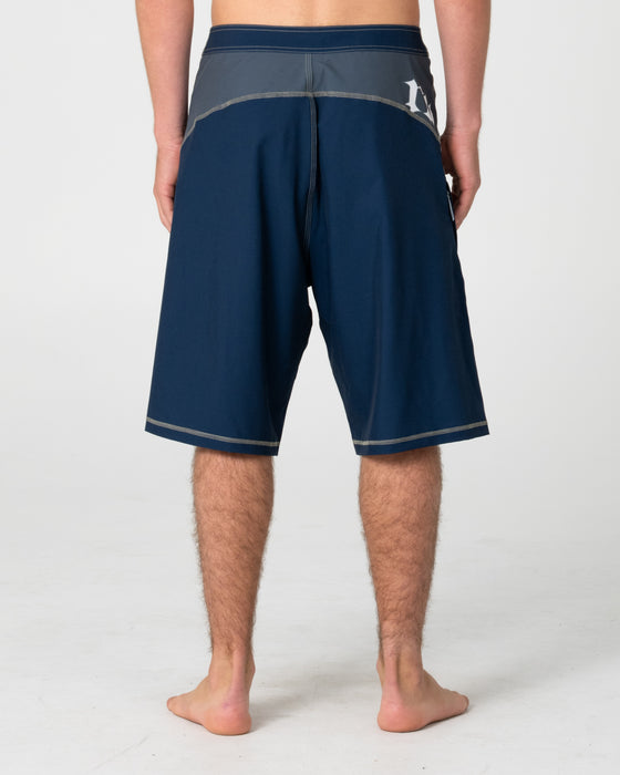 man-wearing-tribalay-fixed-waist-boardshort-in-navy-blue