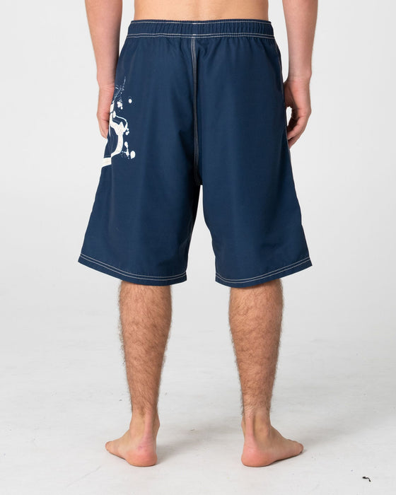man-wearing-ceathair-hybrid-waist-boardshort-in-navy-blue