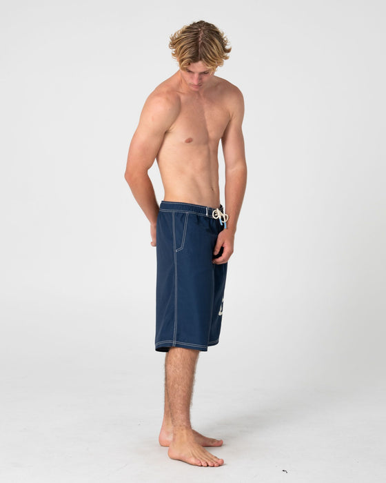 man-wearing-ceathair-hybrid-waist-boardshort-in-navy-blue
