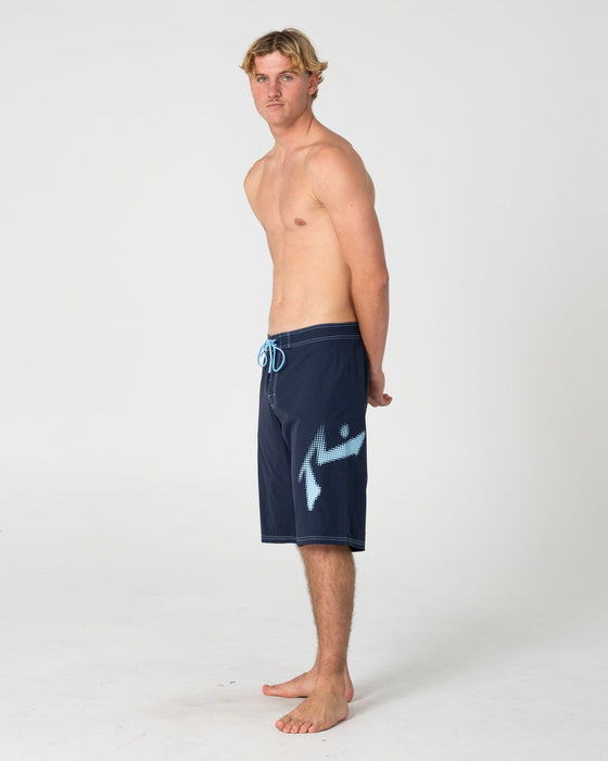 man-wearing-competition-revolution-2-0-boardshort-in-navy-blue