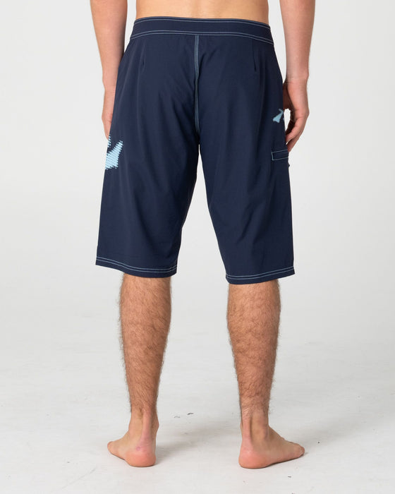 man-wearing-competition-revolution-2-0-boardshort-in-navy-blue