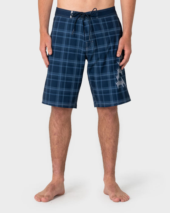 man-wearing-scream-fixed-waist-boardshort-in-navy-blue-plaid