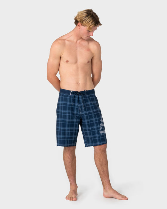 man-wearing-scream-fixed-waist-boardshort-in-navy-blue-plaid