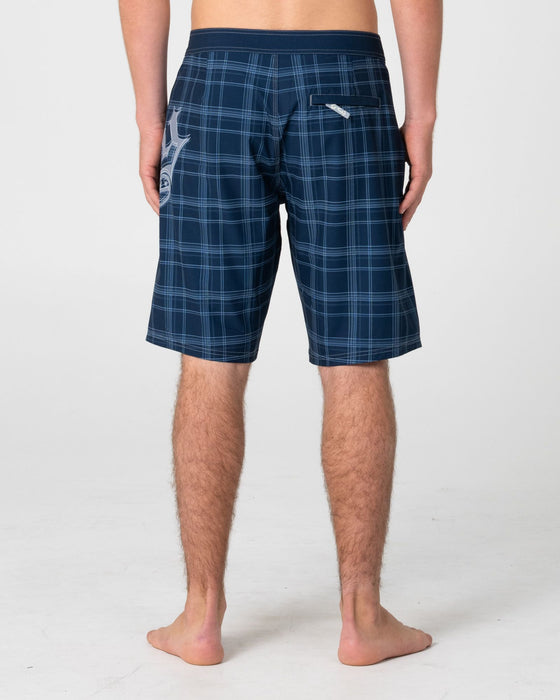 man-wearing-scream-fixed-waist-boardshort-in-navy-blue-plaid