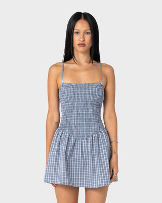 Woman wearing Mimi Smocked Mini Dress in Blue Check
