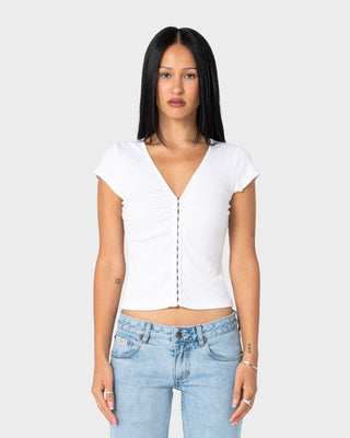 Woman wearing Im Hooked Cap Sleeve Fashion Top in White