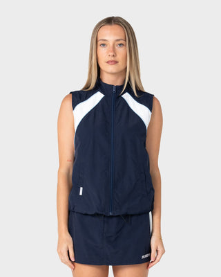 Woman wearing Lombardi Zip Through Nylon Vest in Navy Blue / White