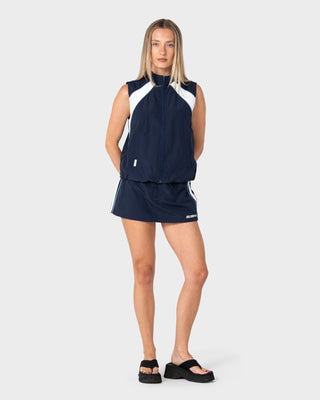 Woman wearing Lombardi Zip Through Nylon Vest in Navy Blue / White