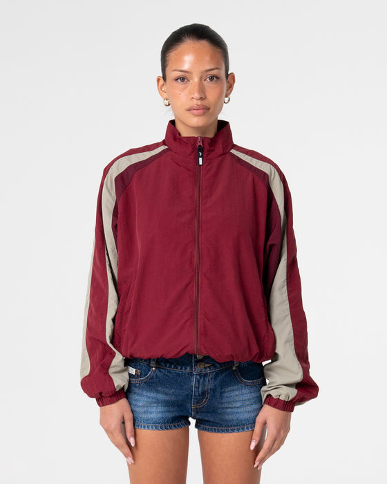 woman-wearing-breezy-wind-cheater-zip-through-jacket-in-cranberry