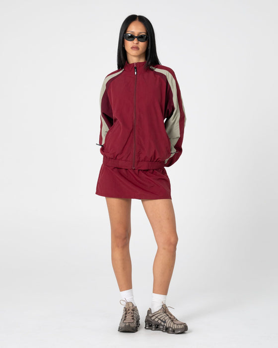 woman-wearing-breezy-wind-cheater-zip-through-jacket-in-cranberry
