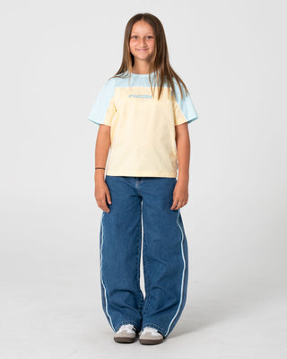 Girl wearing Flip Girl Low Rise Jean in Middy Blue / Blue