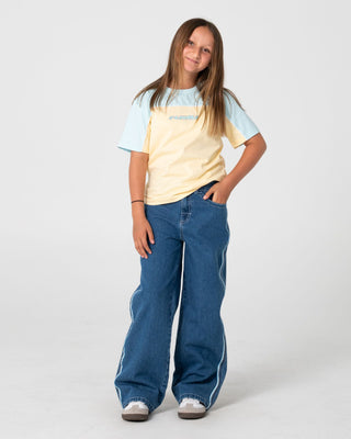 Girl wearing Flip Girl Low Rise Jean in Middy Blue / Blue