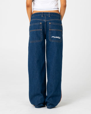 Woman wearing Flip Mommy Low Rise Wide Leg Jean 2.0 in Deep Sea Blue / Orange