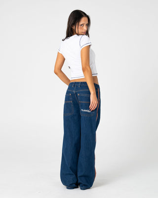 Woman wearing Flip Mommy Low Rise Wide Leg Jean 2.0 in Deep Sea Blue / Orange