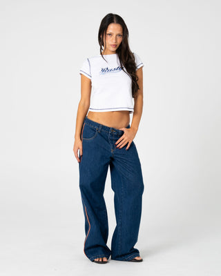 Woman wearing Flip Mommy Low Rise Wide Leg Jean 2.0 in Deep Sea Blue / Orange